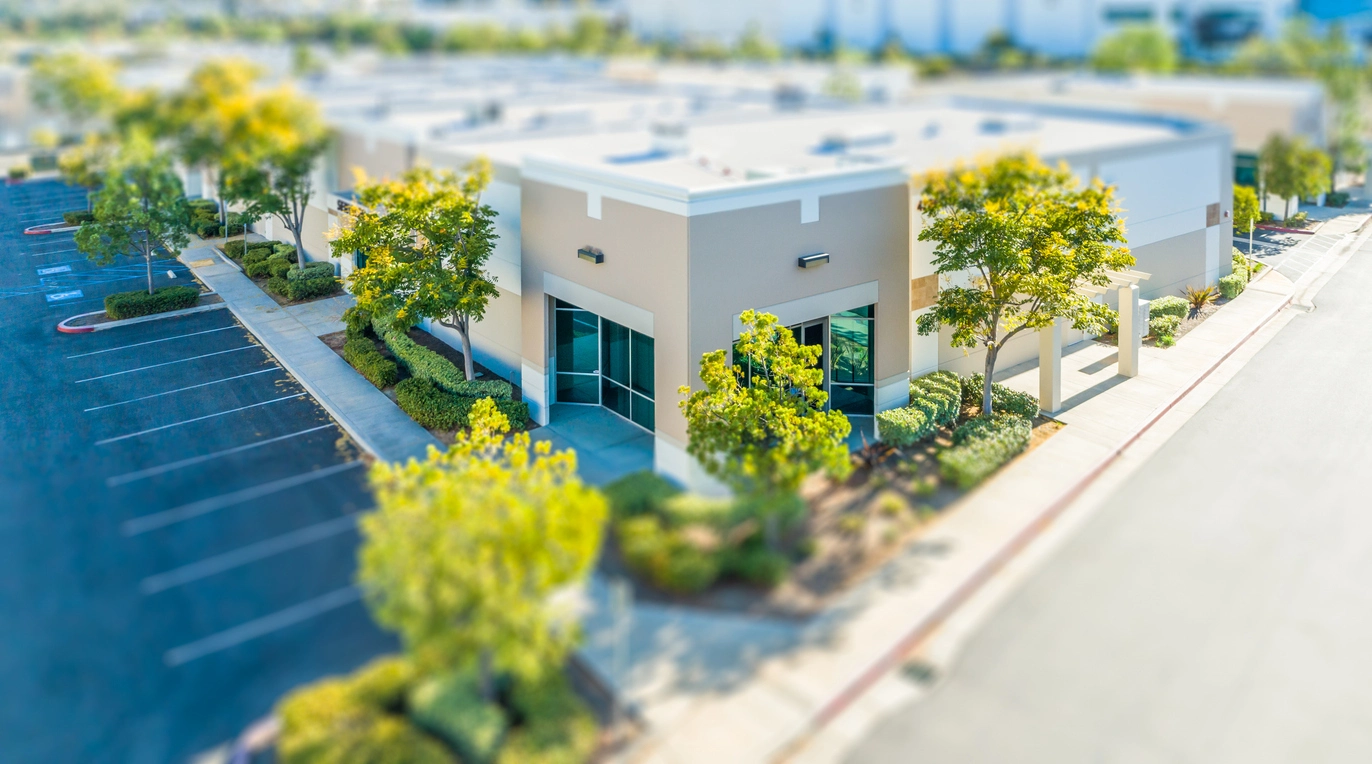 Commercial security camera installer reviewing surveillance coverage at business location