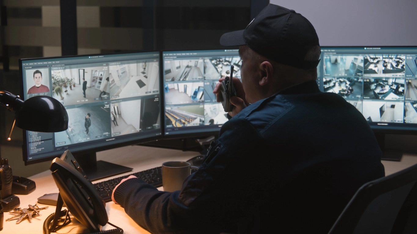 Security operations team viewing remote surveillance feeds for data center facility