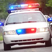 A police car parked with its blue and red lights flashing