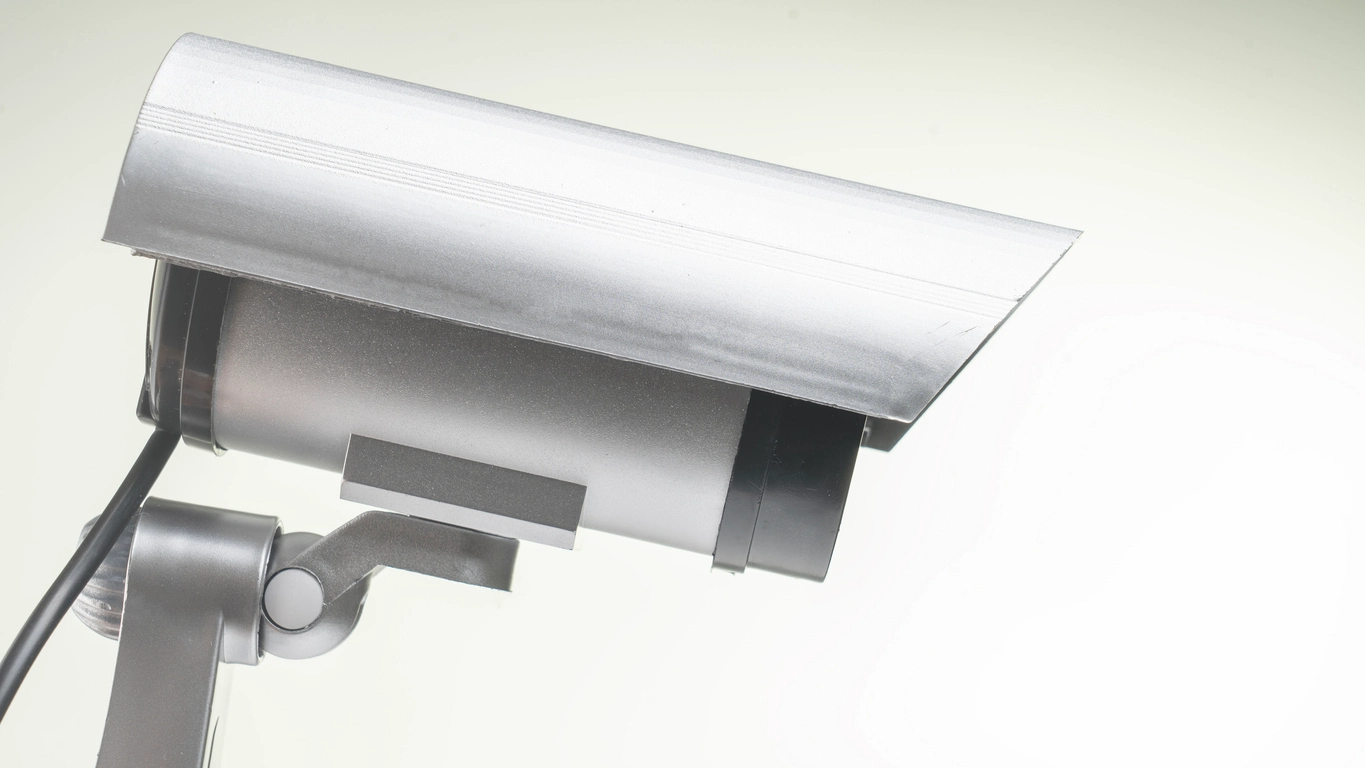 dummy security camera mounted on commercial exterior wall for deterrence