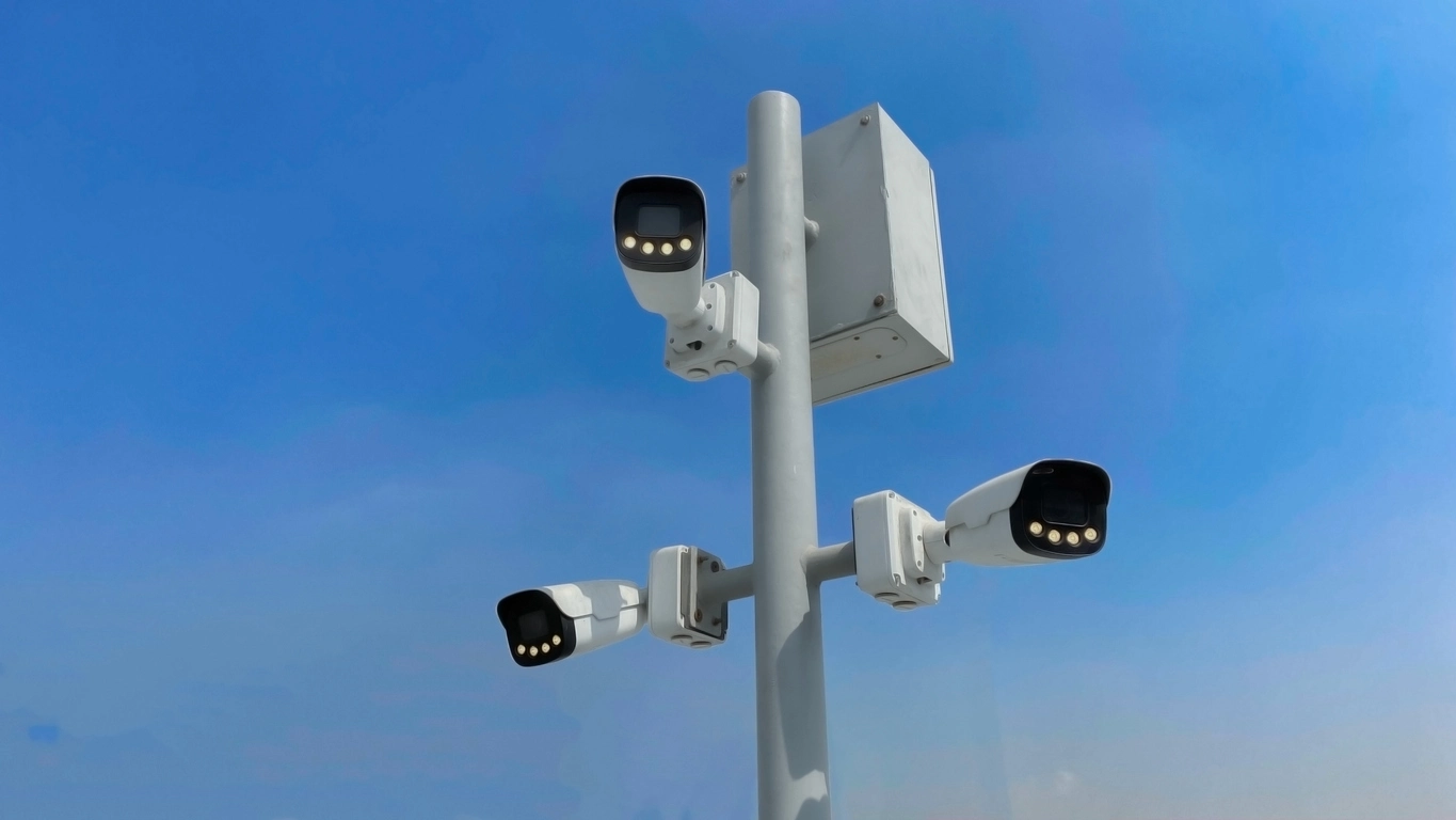 PTZ security camera mounted outdoors monitoring large commercial property