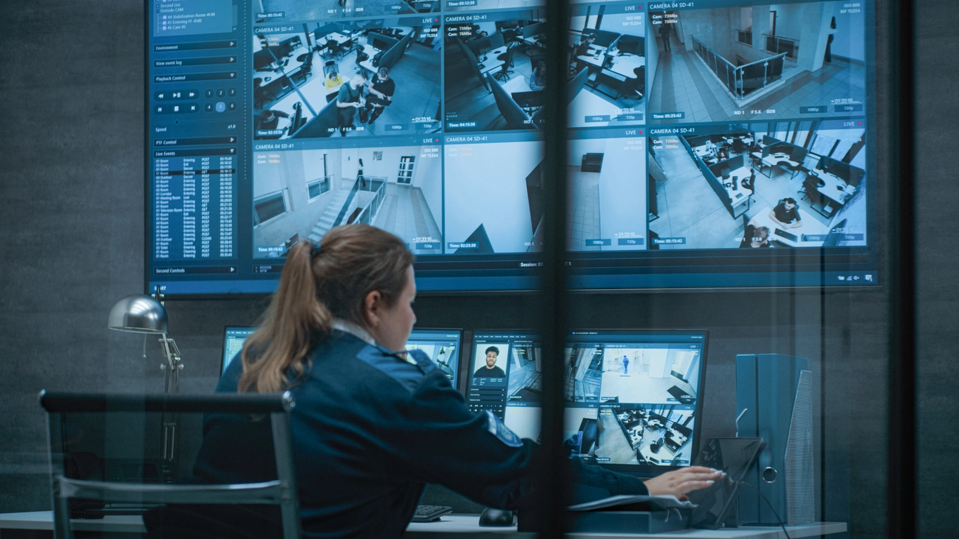 security control room monitoring correctional institution surveillance camera feeds