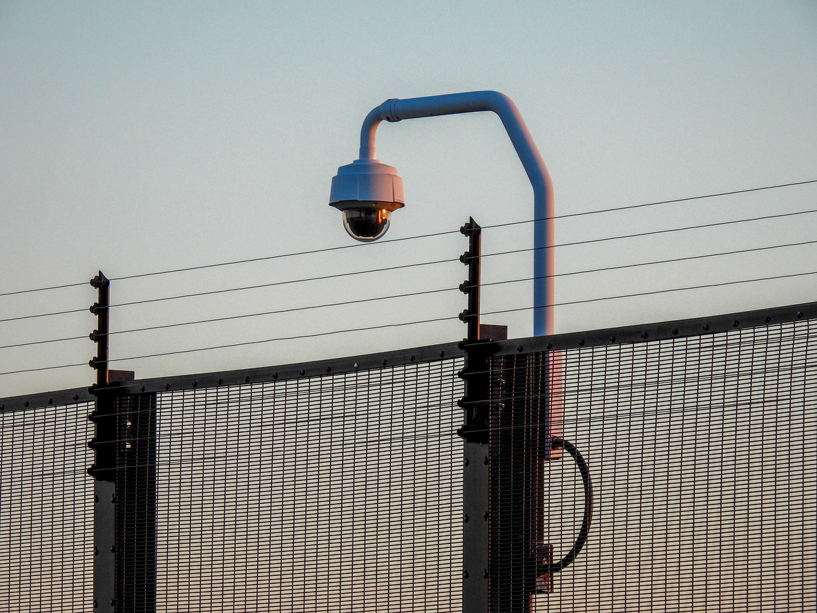 Utility facility perimeter monitored by commercial surveillance