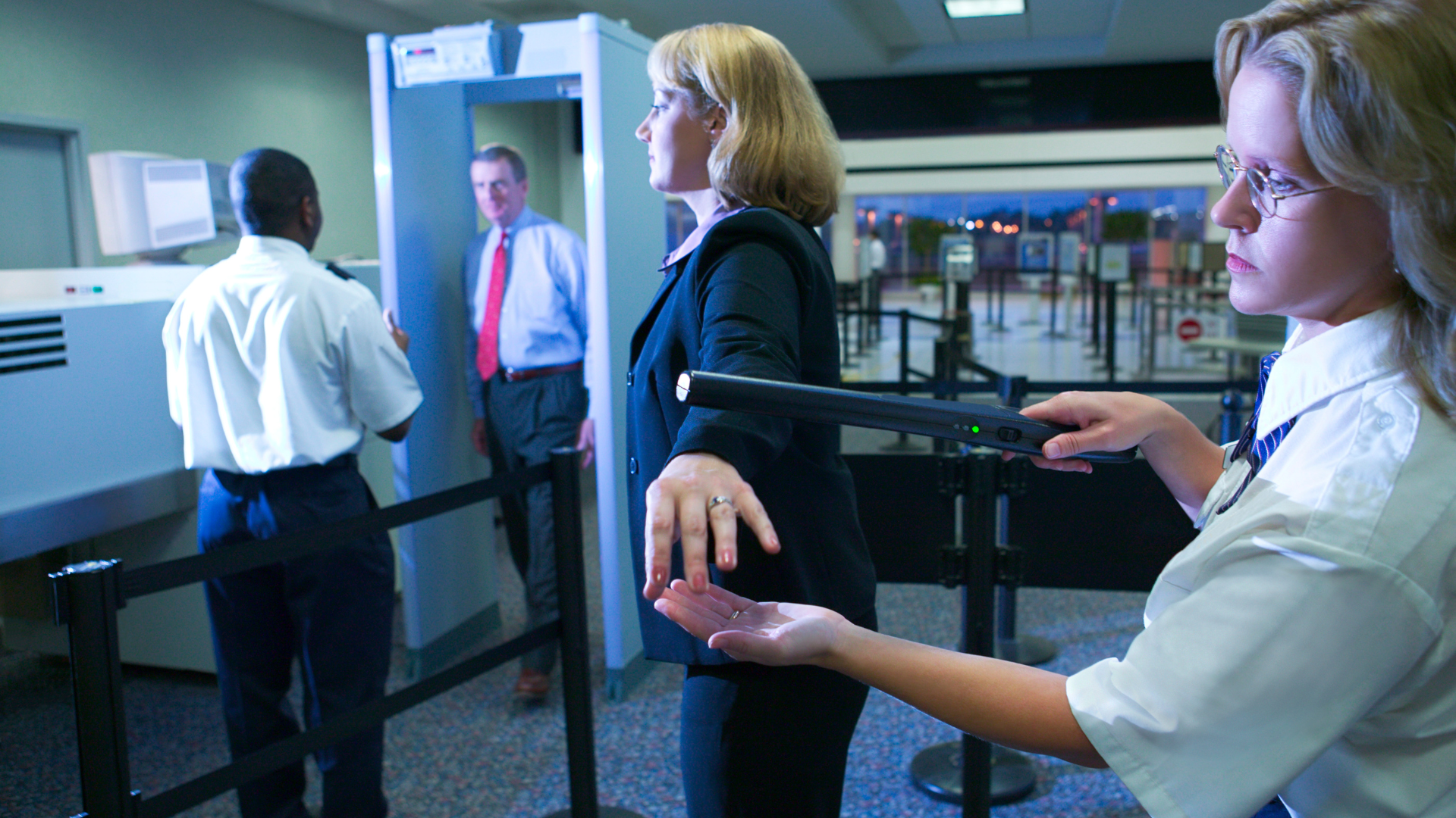 walk-through metal detector screening at a commercial entrance