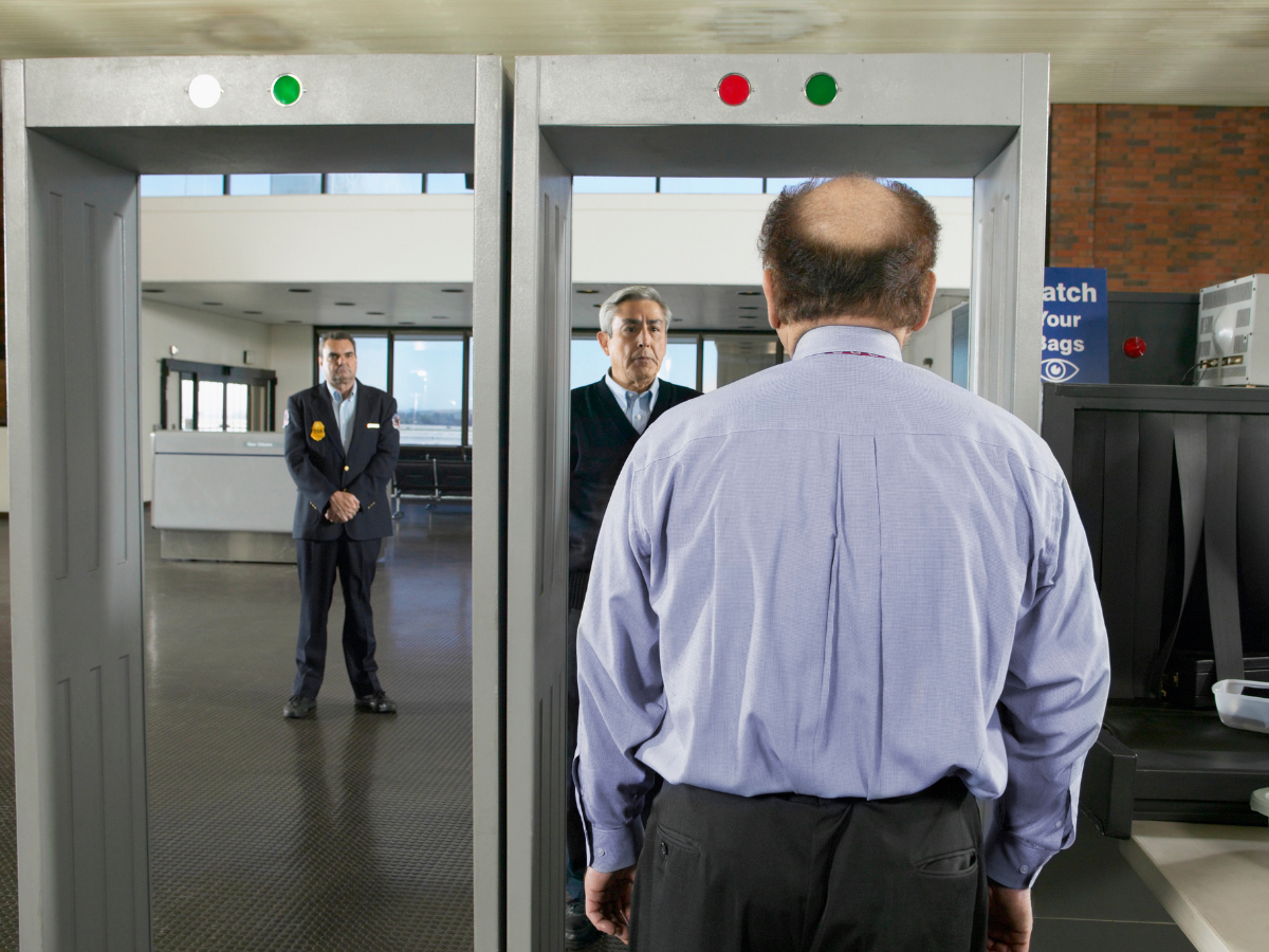 permanently installed walk-through metal detector at a controlled commercial entrance