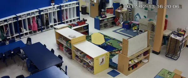 A still from security camera footage of an empty classroom