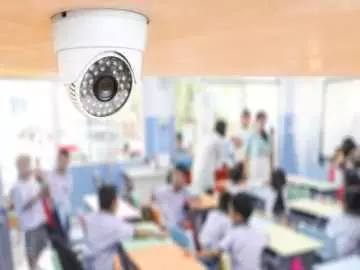 A ceiling mounted camera overlooking a busy classroom