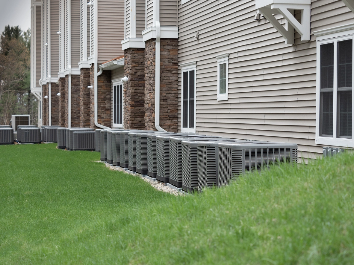 apartment building outdoor condenser units protected by cages