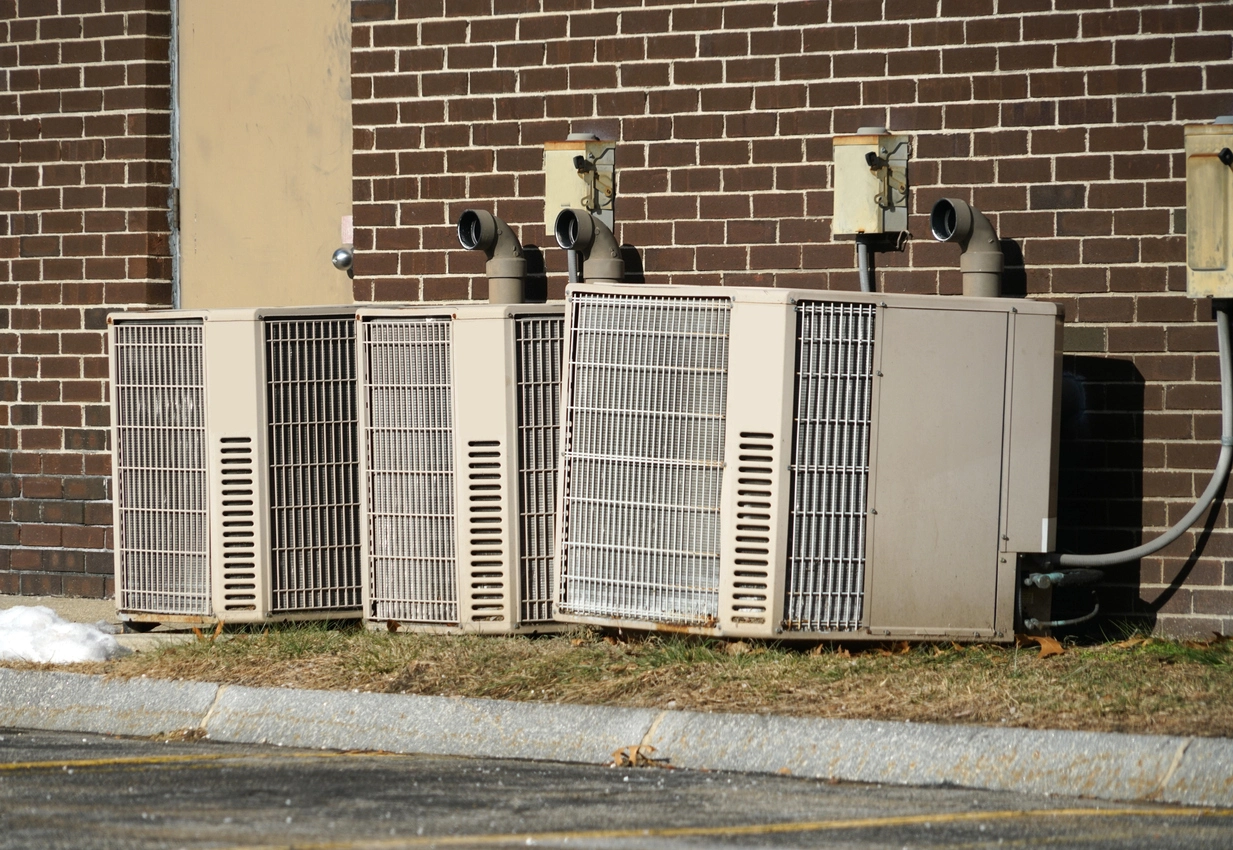 commercial building outdoor AC units protected by security cages
