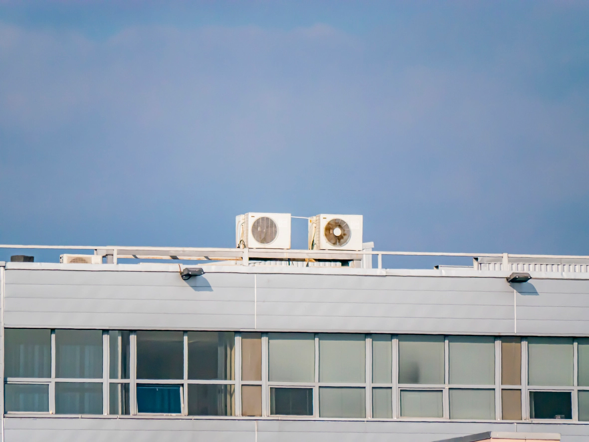 school HVAC outdoor unit protected by metal security cage